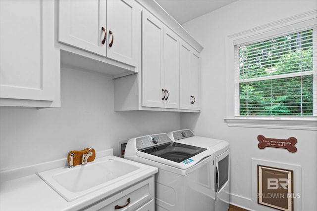 3250 Riviere Du Chien Rd, Mobile, AL 36693 - clothes washing area featuring cabinet space, washing machine and dryer, and baseboards