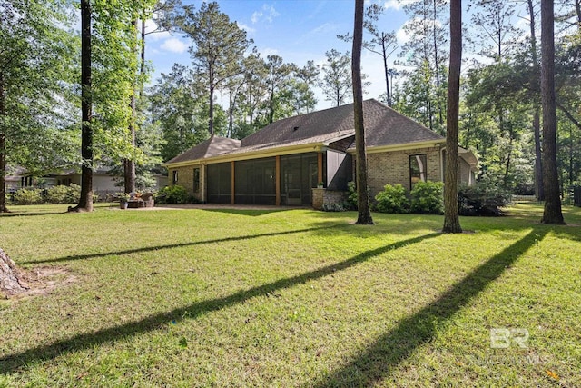 3250 Riviere Du Chien Rd, Mobile, AL 36693 - back of house featuring a sunroom, a yard, and brick siding