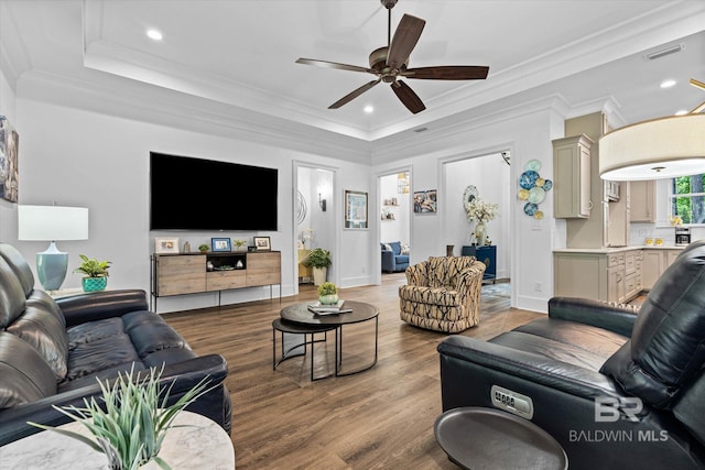 3250 Riviere Du Chien Rd, Mobile, AL 36693 - living area with a tray ceiling, a ceiling fan, wood finished floors, recessed lighting, and crown molding