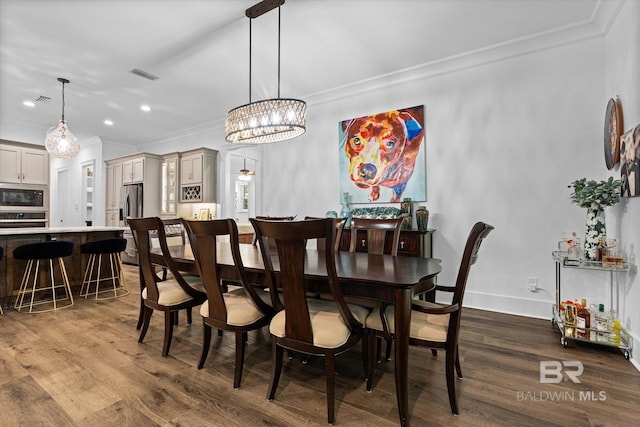 3250 Riviere Du Chien Rd, Mobile, AL 36693 - dining space with crown molding, a chandelier, dark wood-style floors, recessed lighting, and baseboards