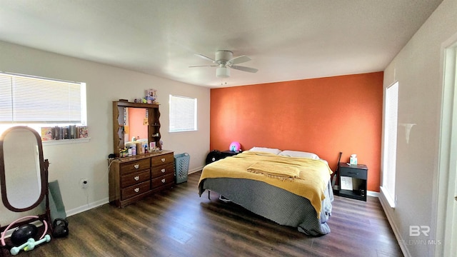 bedroom with a ceiling fan, dark wood-style flooring, and baseboards