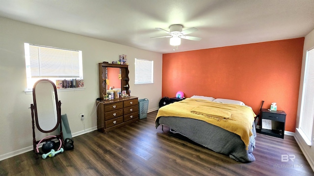 bedroom featuring a ceiling fan, baseboards, and dark wood-style flooring