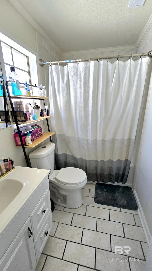 bathroom featuring a textured ceiling, tile patterned flooring, toilet, vanity, and ornamental molding