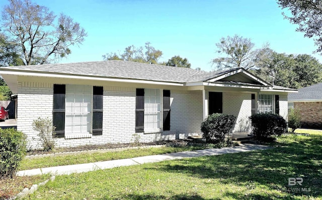 single story home with a front lawn and brick siding