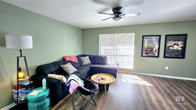 living area with a ceiling fan, baseboards, and wood finished floors