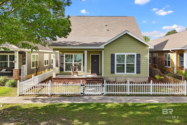 1236 Lavender Ln, Foley, AL 36535 - view of front of house with a porch, a shingled roof, and a fenced front yard