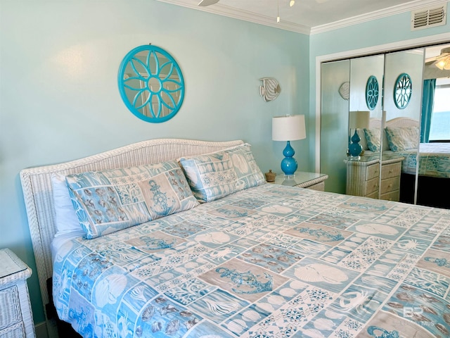 bedroom with a closet, visible vents, and crown molding