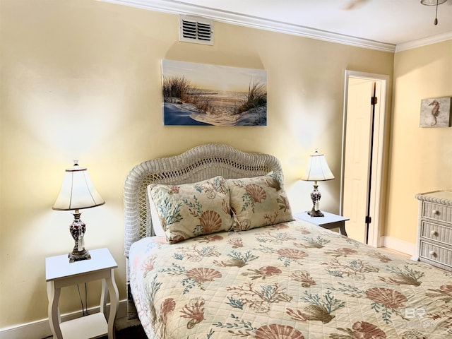 bedroom featuring visible vents, crown molding, and baseboards