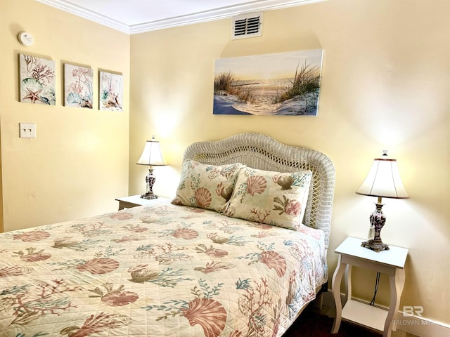 bedroom featuring visible vents and crown molding