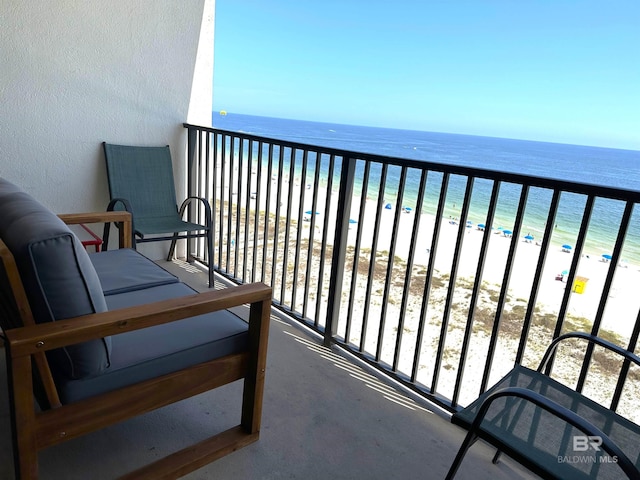 balcony featuring a water view and a view of the beach