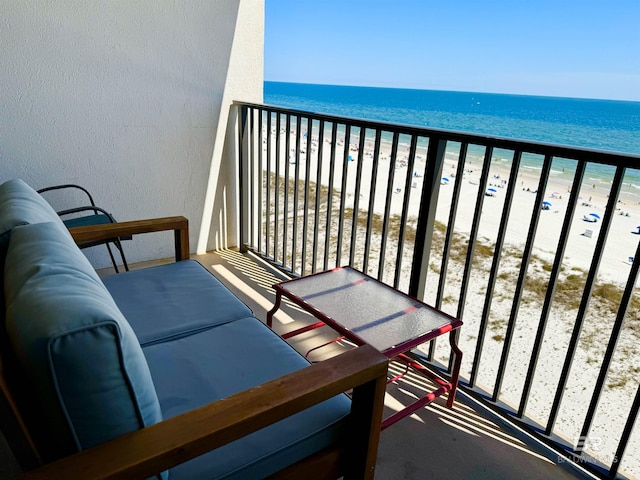 balcony featuring a water view and a view of the beach