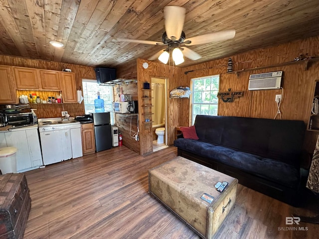 living room featuring hardwood / wood-style floors, plenty of natural light, an AC wall unit, and wooden walls