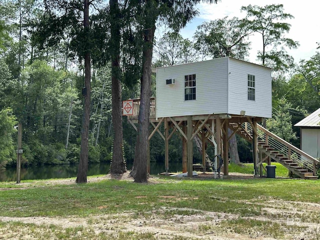 back of property featuring a water view