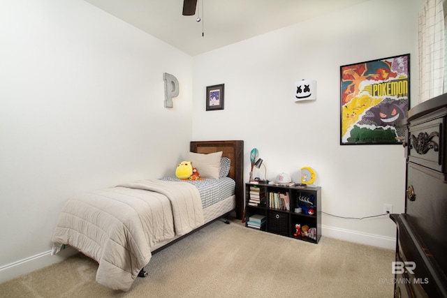 carpeted bedroom featuring baseboards and a ceiling fan