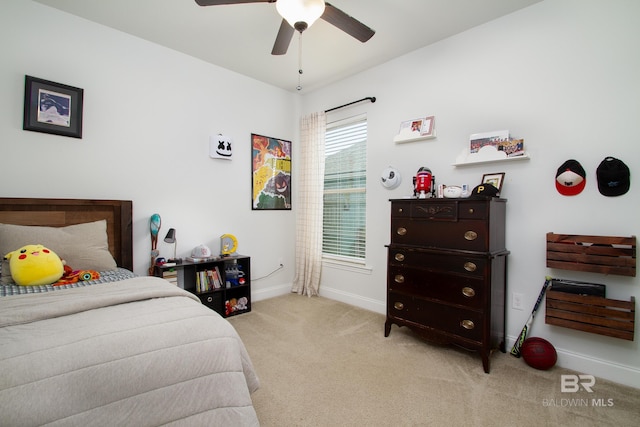bedroom with light colored carpet, baseboards, and ceiling fan