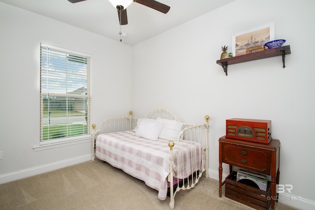 carpeted bedroom with baseboards and ceiling fan