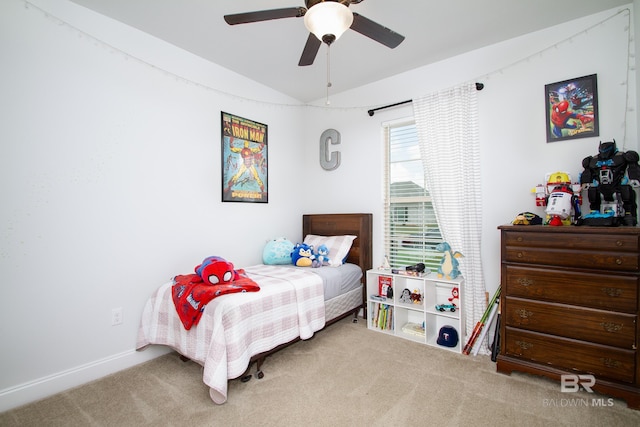 carpeted bedroom with baseboards, a ceiling fan, and vaulted ceiling