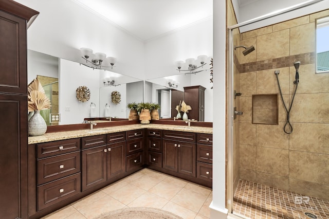 bathroom with tile patterned floors, a shower with door, vanity, and crown molding