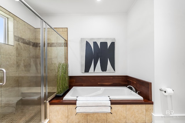 full bathroom featuring a garden tub, crown molding, and a shower stall