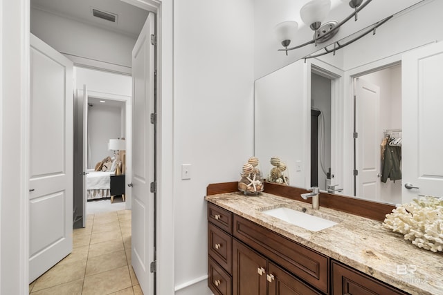 bathroom featuring tile patterned floors, vanity, and connected bathroom