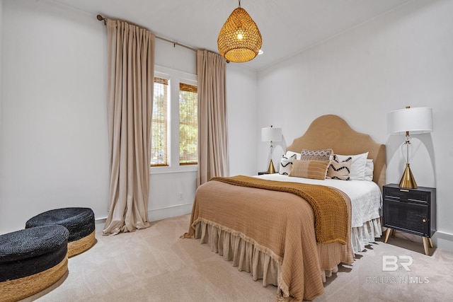 bedroom featuring baseboards and carpet