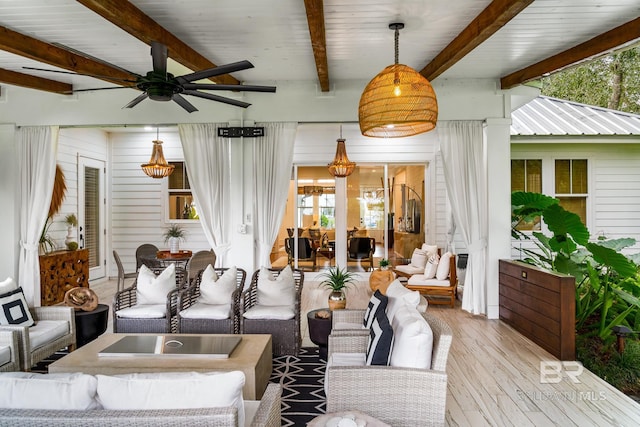 living room with a ceiling fan, wood finished floors, and beam ceiling