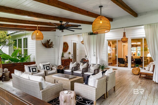 living room with light hardwood / wood-style flooring, wood walls, ceiling fan, and beamed ceiling