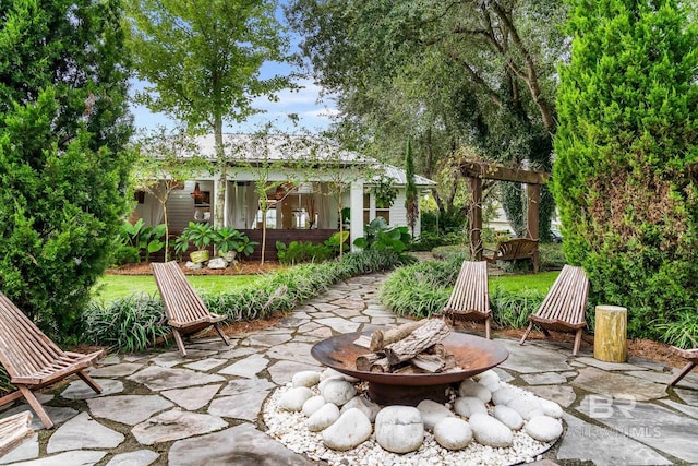 view of patio / terrace featuring an outdoor fire pit