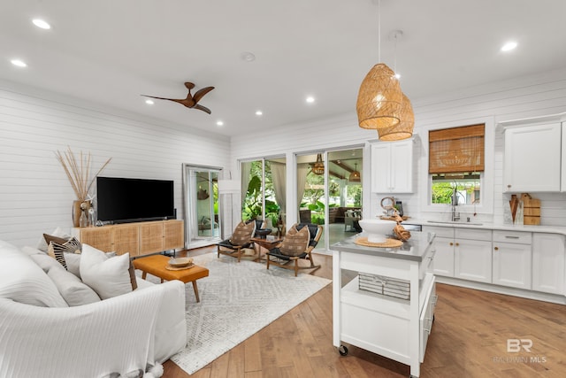 interior space with ceiling fan, light wood-type flooring, and sink