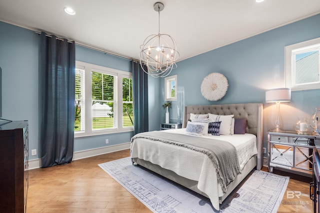 bedroom with baseboards, recessed lighting, wood finished floors, and a notable chandelier