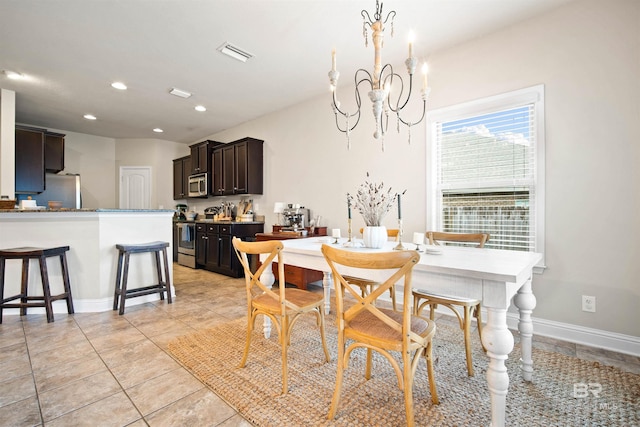 dining room with a notable chandelier and light tile patterned floors