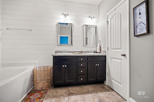 bathroom featuring vanity and a tub to relax in