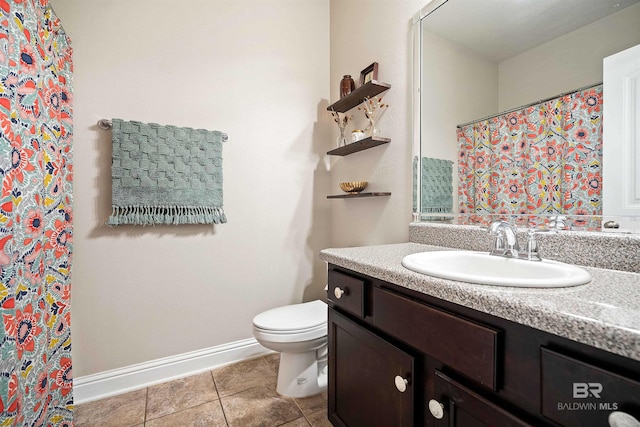 bathroom featuring toilet, vanity, and tile patterned floors