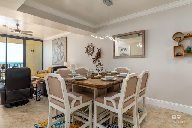 tiled dining room with ceiling fan and crown molding