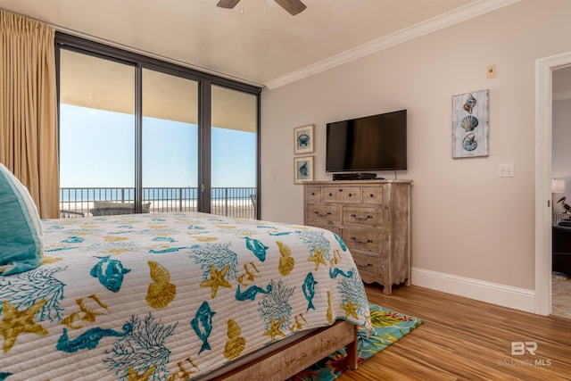 bedroom featuring light hardwood / wood-style floors, a water view, ornamental molding, ceiling fan, and access to outside