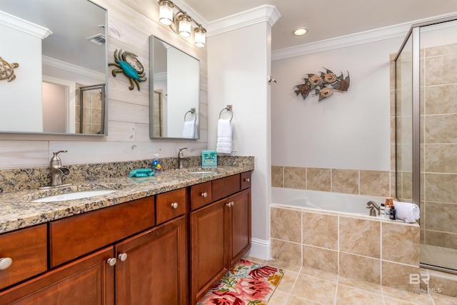 bathroom featuring shower with separate bathtub, tile patterned floors, crown molding, and vanity