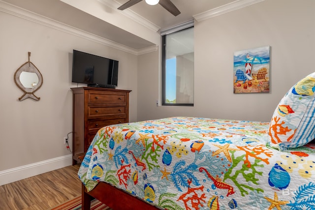 bedroom with ornamental molding, hardwood / wood-style flooring, and ceiling fan