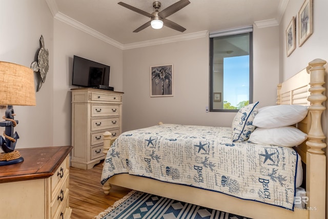 bedroom with light hardwood / wood-style floors, ceiling fan, and crown molding