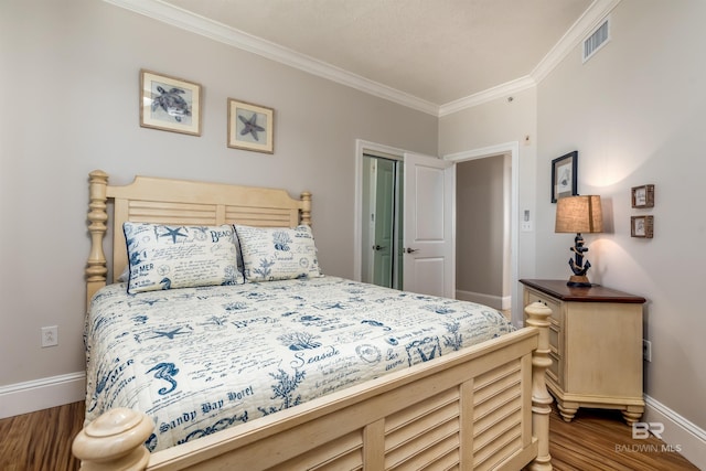 bedroom with hardwood / wood-style flooring and crown molding