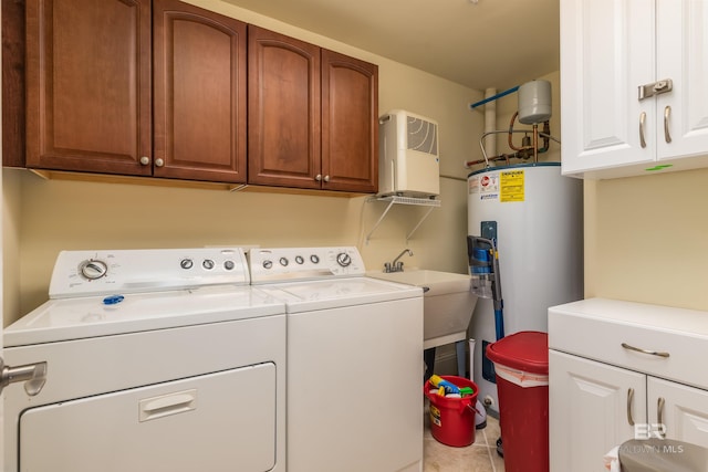 washroom with cabinets, sink, electric water heater, washing machine and dryer, and tile patterned floors