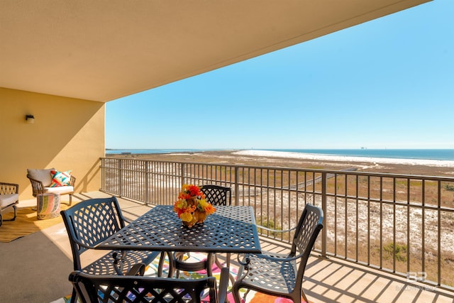 balcony with a view of the beach and a water view