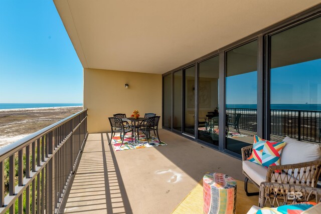 balcony with a beach view and a water view