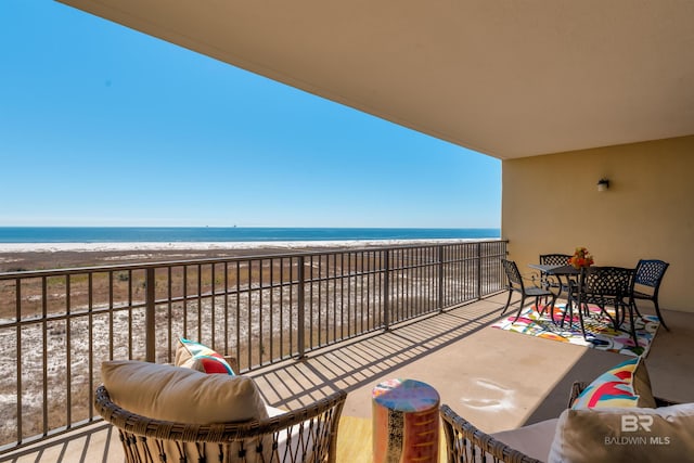 balcony with a view of the beach and a water view