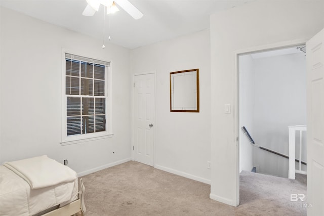 unfurnished room featuring ceiling fan and light colored carpet