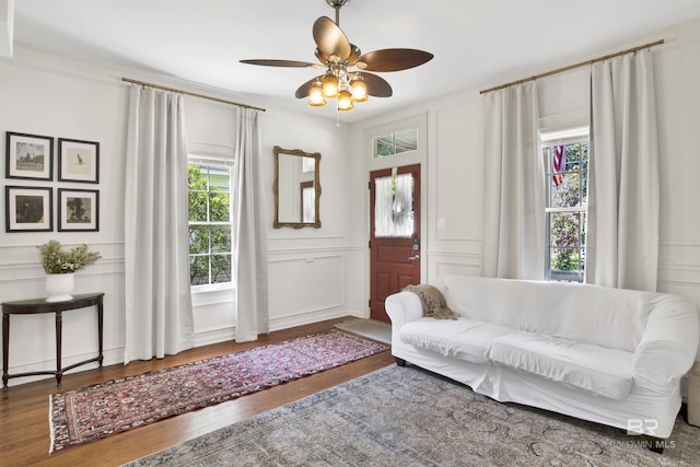 interior space with a wealth of natural light, ceiling fan, and hardwood / wood-style flooring