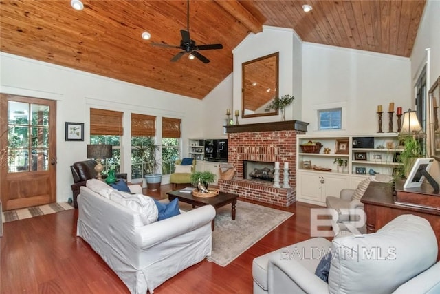 living room with ceiling fan, dark hardwood / wood-style flooring, high vaulted ceiling, wooden ceiling, and a fireplace