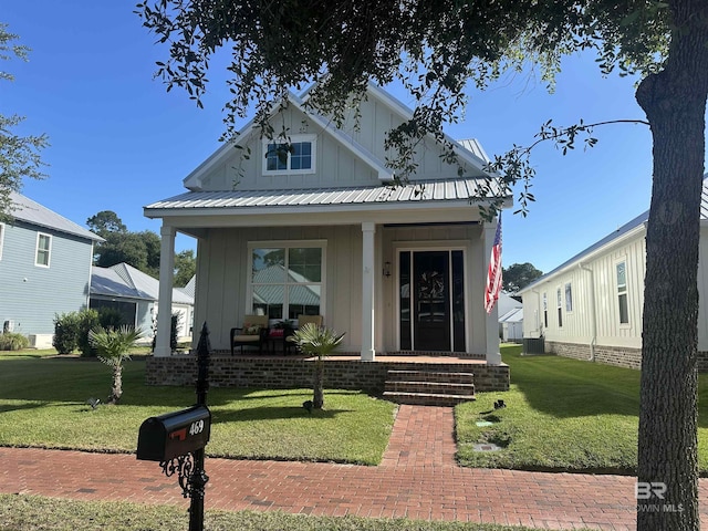 469 Orleans St, Gulf Shores, AL 36542 - view of front of house featuring board and batten siding, a porch, and a front yard