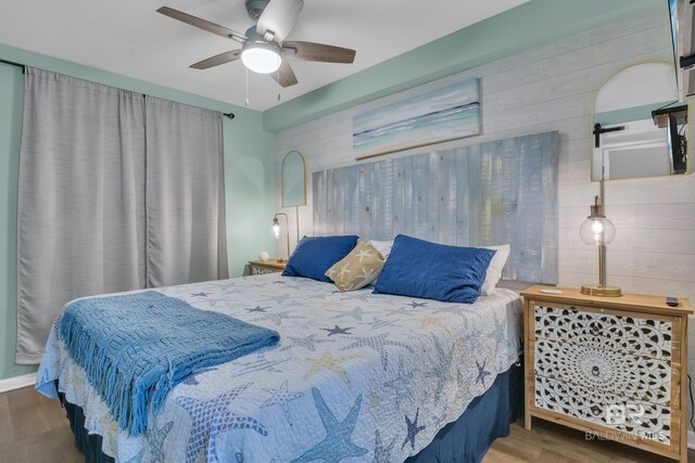 24522 Perdido Beach Blvd Unit 3705, Orange Beach, AL 36561 - bedroom with wood finished floors, wood walls, and a ceiling fan