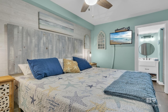24522 Perdido Beach Blvd Unit 3705, Orange Beach, AL 36561 - bedroom with ensuite bathroom, a ceiling fan, and wood finished floors