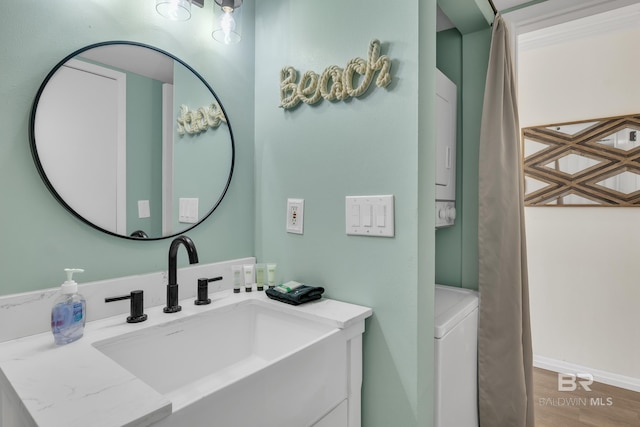 24522 Perdido Beach Blvd Unit 3705, Orange Beach, AL 36561 - bathroom featuring wood finished floors, vanity, and washer / dryer